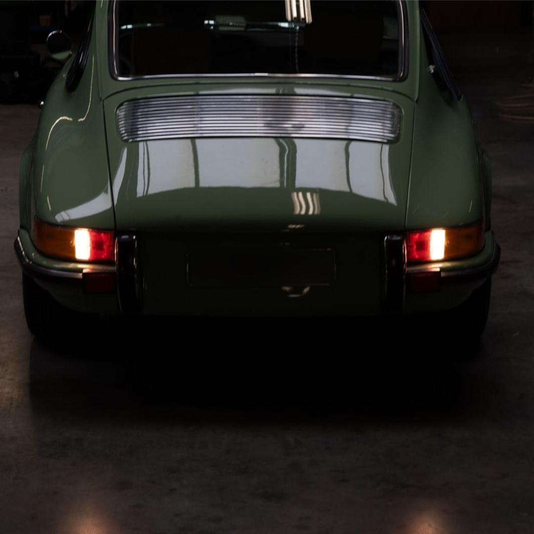 Rear view of a green Revolt Electric in a dark interior