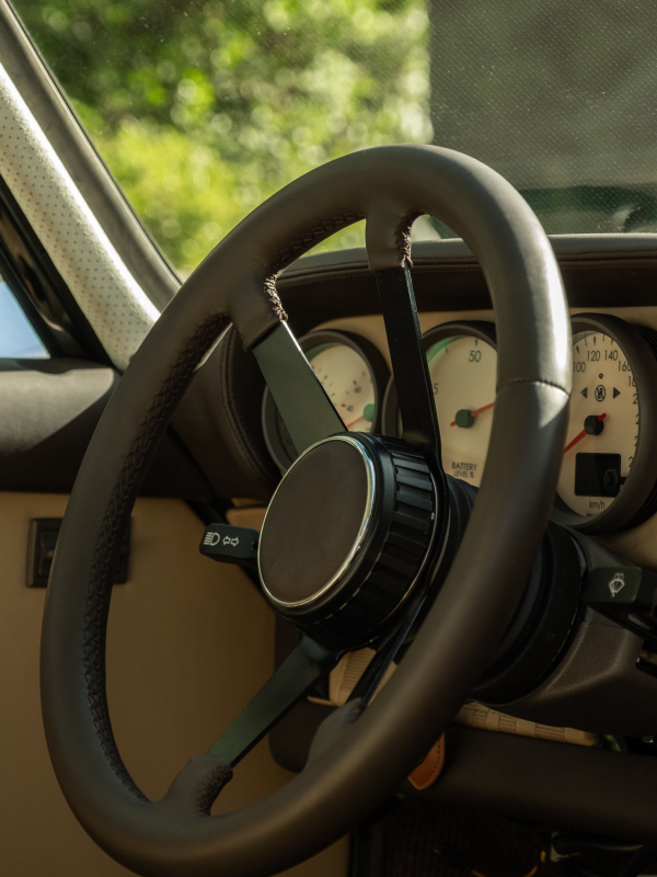 Steering wheel and tan dashboard inside the Revolt Electric